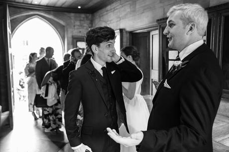 the groom greets a wedding guest