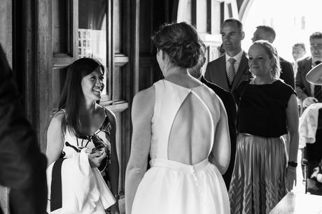 the bride greets a wedding guest