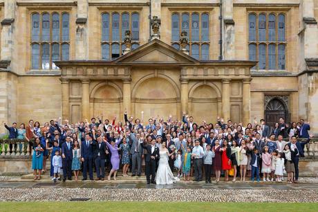 wedding guests on the tribune steps at trinity college cambridge