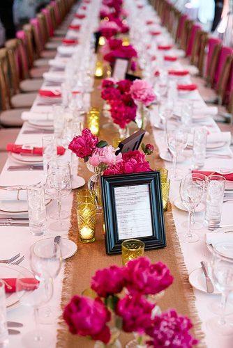 wedding centerpieces with crimson rose peonies and warm candles matt blum photography