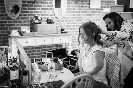 bride having her hair done before the wedding