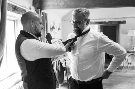 the groom helps his brother get ready