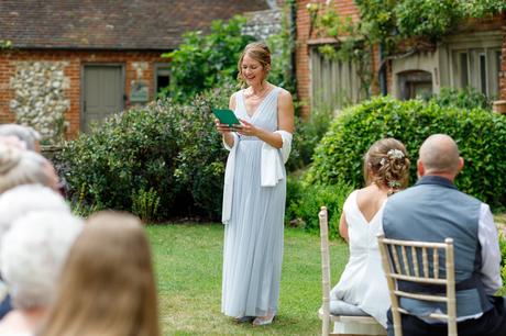 the brides sister reads during a hautbois hall ceremony