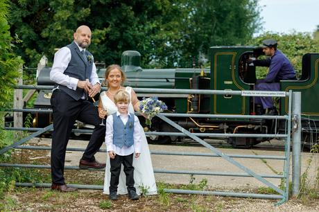 bride and groom in front of the bure valley railway