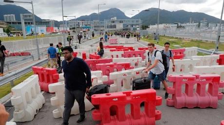 Protesters block roads near Hong Kong airport as clashes continue