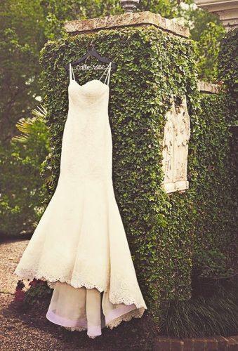 hanging wedding dress dress on greet wall sallyveephotography