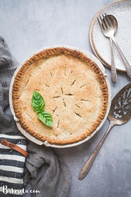 This Vegan Pot Pie has a scrumptious flaky gluten-free & paleo crust and the creamy filling is absolutely loaded with vegetables! This hearty, filling meal is perfect for chilly days and freezes well.