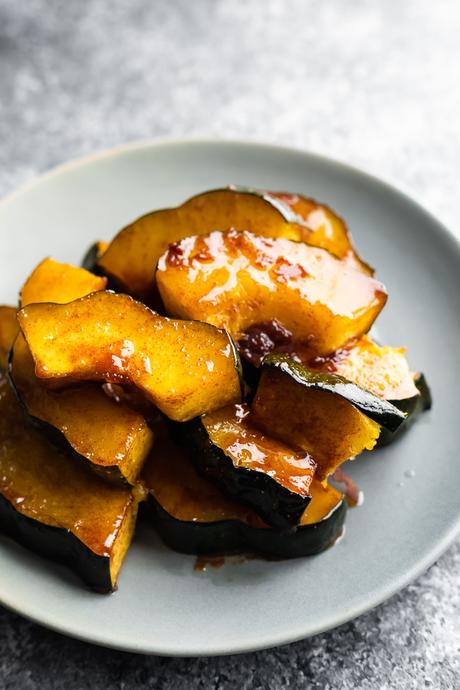 roasted acorn squash on gray plate with sticky glaze