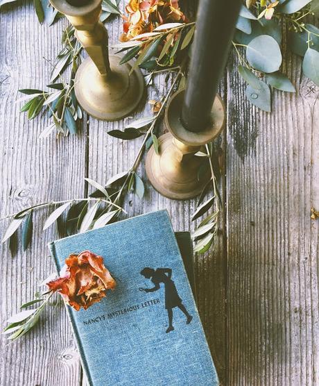 a Halloween tablescape with a mystery book theme a Halloween tablescape with a mystery book theme