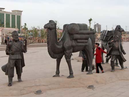 Statues reflecting travellers on the old Silk Road