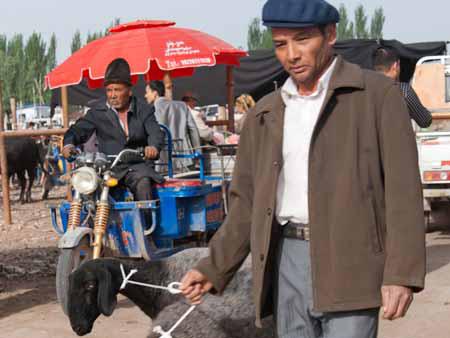 A Uighur men and his two goats