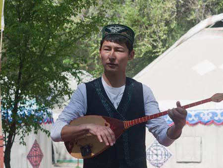 Kyrgyzstan man playing the komuz and singing traditional music