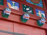 Three traditional lions heads above a doorway