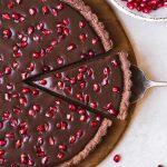 This No-Bake Chocolate Pomegranate Tart is made with 8 simple ingredients and is perfect for holiday entertaining! No baking required for this gluten-free, paleo, and vegan tart.