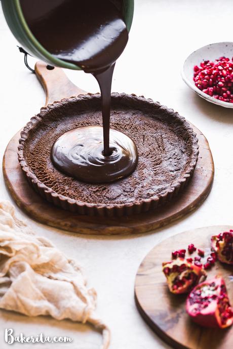 This No-Bake Chocolate Pomegranate Tart is made with 8 simple ingredients and is perfect for holiday entertaining! No baking required for this gluten-free, paleo, and vegan tart.