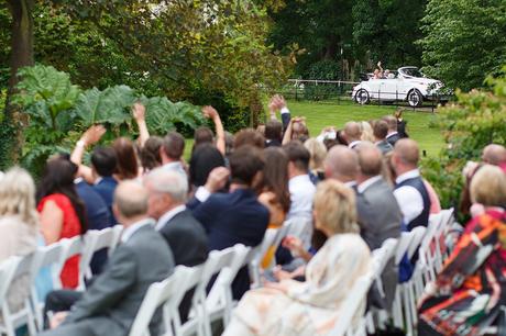 100 Best Barn Wedding Photos a bride arrives in the wedding car behind her guests