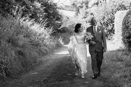 a bride and her father walk to the wedding ceremony at gate street barn