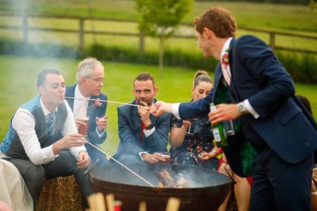 100 Best Barn Wedding Photos feeding guests marshmallows at a godwick barn wedding