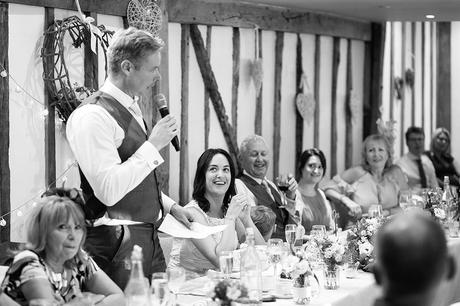100 Best Barn Wedding Photos the bride laughs at the grooms speech