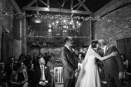 the bride kisses her father at a curradine barn wedding