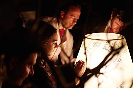 100 Best Barn Wedding Photos guests sign a lampshade at a barn wedding