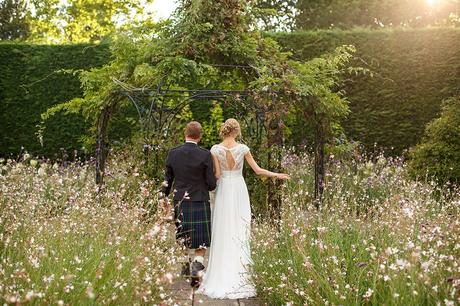 100 Best Barn Wedding Photos bride and groom walk through the gardens at gaynes park
