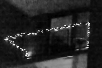 A small balcony, with ornamental lighting, shot at night in Hoboken, with Photoshopped variations