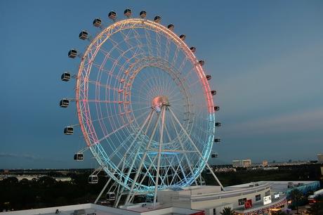 The Wheel at ICON Park in Orlando at night with coloured lights