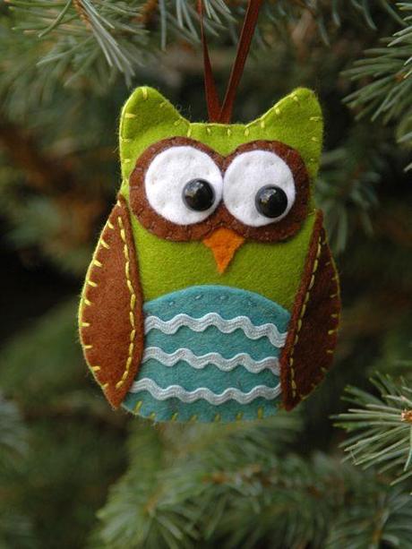 An owl ornament hanging on a Christmas tree