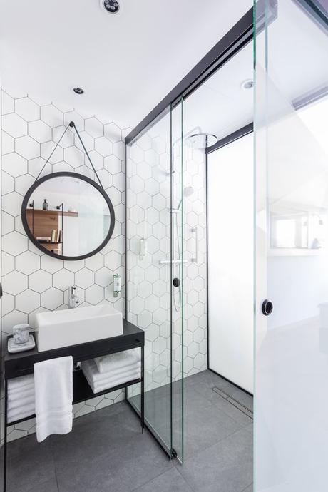 simple black single vessel sink bathroom vanity with geometric tile backsplash