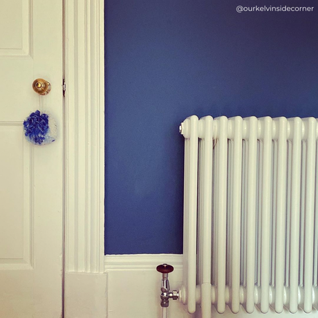 white column radiator on a classic blue wall