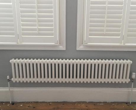 a white Milano Windsor column radiator under a window