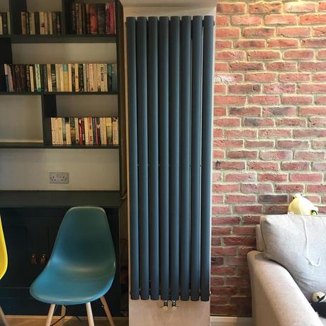 vertical radiator on a brick wall