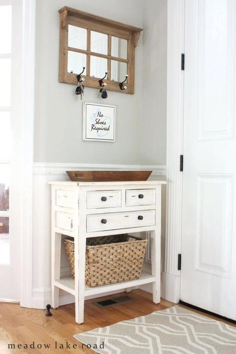 small entry mirror entryway with hooks table and key above