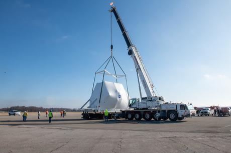 The Orion spacecraft being lifted onto the truck for transport to NASA's Plum Brook Station