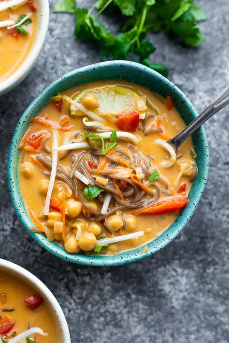 overhead view of coconut curry soup with cilantro in background