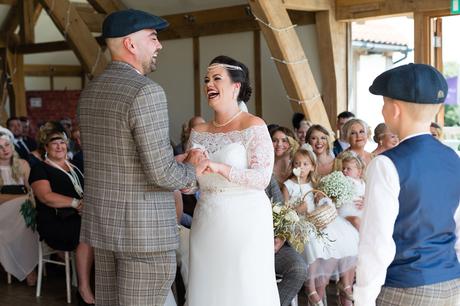 Bride laughs as the couple exchange rings at Sandburn Hall wedding. 