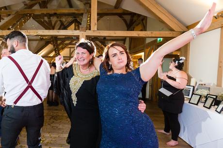 Guests dancing at York wedding with woman in blue dress. 