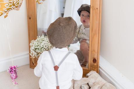Peaky Blinders styled pageboy making silly faces in mirror at Sandburn Hall Wedding. 