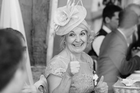 Bride's mother gives thumb's up and smiles at East Riddlesden Hall wedding. 