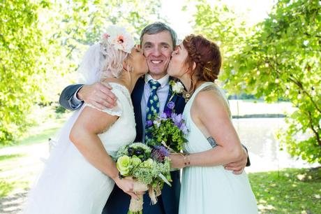 Bride and twin sister kiss her dad on the cheeks at East Riddlesden Hall