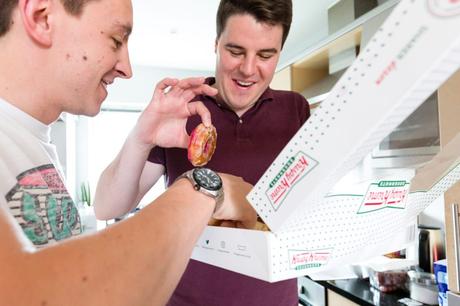 Groomsmen eat Krispy Kreme doughnuts at Asylum wedding. 