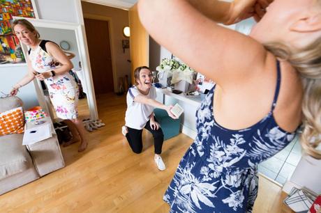 Bride laughs as friend pretends to propose at fun, london wedding. 