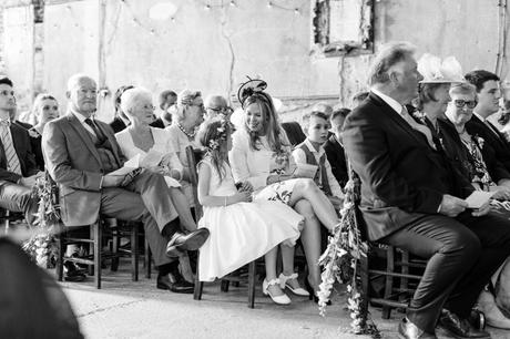 Little flower girl and mother smile at each other during ceremony at Asylum. 