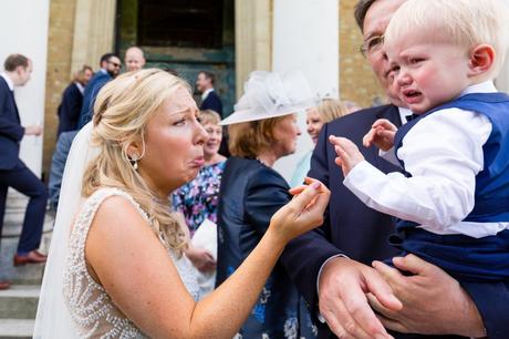 Bride makes sad face at little boy at Asylum wedding. 