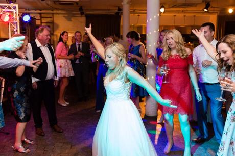 Bride does John Travolta disco move on the dance floor at her London wedding. 