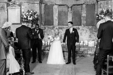 Bride laughs as she walks up the aisle. 