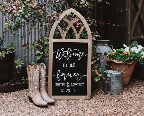 modern country love songs boots with wedding sign