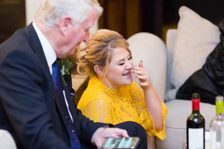 Wedding guest smiling wearing a yellow lace dress