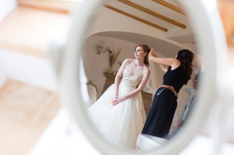 Reflection of redheaded bride in mirror at wedding in Inverness